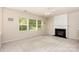 Bright living room featuring a fireplace, ample windows, and neutral tones for a calming atmosphere at 11220 Cypress View Dr, Charlotte, NC 28262