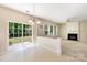 Open concept living room with sliding door, tile floor, and fireplace with white mantle at 11220 Cypress View Dr, Charlotte, NC 28262