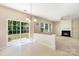 Open concept living room with sliding door, tile floor, and fireplace with white mantle at 11220 Cypress View Dr, Charlotte, NC 28262