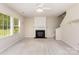 Cozy living room featuring a fireplace, large windows, and ample space for comfortable seating at 11220 Cypress View Dr, Charlotte, NC 28262