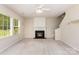 Cozy living room featuring a fireplace, large windows, and ample space for comfortable seating at 11220 Cypress View Dr, Charlotte, NC 28262