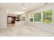 Sun-filled living room view, connecting to the kitchen, with multiple windows and an overhead fan at 11220 Cypress View Dr, Charlotte, NC 28262