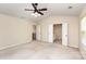 Spacious bedroom featuring a ceiling fan, neutral paint, an ensuite bathroom and a walk-in closet at 11220 Cypress View Dr, Charlotte, NC 28262