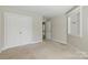 A carpeted bedroom featuring double closets, a window, and neutral colors at 1139 Hampton Gardens Ln, Charlotte, NC 28209
