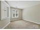 A cozy bedroom with natural light and neutral carpeting at 1139 Hampton Gardens Ln, Charlotte, NC 28209