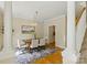 Bright dining room with hardwood floors, columns, and a modern chandelier at 1139 Hampton Gardens Ln, Charlotte, NC 28209
