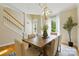 Bright dining room with hardwood floors, columns, and a modern chandelier at 1139 Hampton Gardens Ln, Charlotte, NC 28209