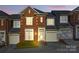 Charming brick townhouse with a well-maintained front yard and attached garage at 1139 Hampton Gardens Ln, Charlotte, NC 28209