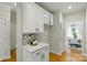The open kitchen features a granite countertop and white cabinets at 1139 Hampton Gardens Ln, Charlotte, NC 28209