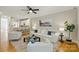 Open concept living room features a ceiling fan and a view of the kitchen at 1139 Hampton Gardens Ln, Charlotte, NC 28209