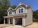 Two-story new construction home with attached garage and neutral toned exterior at 1142 Forest Dr, Marshville, NC 28103