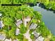 Aerial view of a neighborhood with mature trees near a lake with property lines shown at 11732 Borchetta Dr, Charlotte, NC 28277