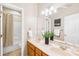 Bathroom featuring a double vanity, large mirror, and shower/tub combo at 11732 Borchetta Dr, Charlotte, NC 28277