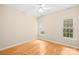 Bedroom with hardwood floors, white trim, and ample natural light from two windows at 11732 Borchetta Dr, Charlotte, NC 28277