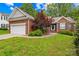 Well-maintained brick home with an attached garage and lush green lawn at 11732 Borchetta Dr, Charlotte, NC 28277