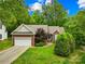 Well-maintained brick home featuring a lush green lawn and attached two-car garage at 11732 Borchetta Dr, Charlotte, NC 28277