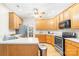 Well-lit kitchen with wooden cabinets, stainless steel appliances, and hardwood floors at 11732 Borchetta Dr, Charlotte, NC 28277