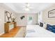 Bright main bedroom with tray ceiling, fan, light hardwood floors and ensuite entrance at 11732 Borchetta Dr, Charlotte, NC 28277