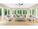 Beautiful sun room filled with natural light, accentuated by walls of large windows at 11732 Borchetta Dr, Charlotte, NC 28277