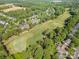 Expansive aerial shot highlighting the golf course, surrounding homes, and verdant landscaping in the community at 12004 Willingdon Rd, Huntersville, NC 28078