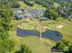 Panoramic aerial view showcasing golf course, ponds, and community amenities in a picturesque setting at 12004 Willingdon Rd, Huntersville, NC 28078