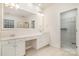 Large bathroom featuring double vanity sinks, ample counter space, and a walk-in closet at 12004 Willingdon Rd, Huntersville, NC 28078