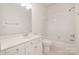 Neutral bathroom with a toilet, bathtub and cabinet at 12004 Willingdon Rd, Huntersville, NC 28078