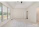 Bright bedroom with large window, tray ceiling, and neutral carpet and decor at 12004 Willingdon Rd, Huntersville, NC 28078
