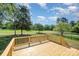 Large wooden deck overlooking a well-maintained lawn and golf course at 12004 Willingdon Rd, Huntersville, NC 28078