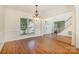 Bright, open dining room showcasing hardwood floors, large window, and an open floorplan at 12004 Willingdon Rd, Huntersville, NC 28078