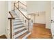 Spacious foyer features hardwood floors, staircase, and views into other rooms, enhancing the home's flow at 12004 Willingdon Rd, Huntersville, NC 28078