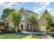 Charming brick two-story home features mature trees, lush landscaping, and a welcoming entrance at 12004 Willingdon Rd, Huntersville, NC 28078