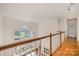 Open foyer with hardwood floors, a large arched window, and a view of the living spaces below at 12004 Willingdon Rd, Huntersville, NC 28078