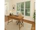 Bright home office featuring a modern desk, neutral decor, and ample natural light from large windows at 12004 Willingdon Rd, Huntersville, NC 28078