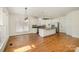 Spacious kitchen with a large island, white cabinetry, stainless steel appliances, and hardwood floors at 12004 Willingdon Rd, Huntersville, NC 28078