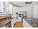 Kitchen area featuring granite countertops, stainless steel appliances, white cabinets, and hardwood floors at 12004 Willingdon Rd, Huntersville, NC 28078