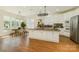 Well-lit kitchen featuring a center island, modern appliances, and an adjacent dining area with natural light at 12004 Willingdon Rd, Huntersville, NC 28078