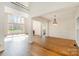 Open-concept living space with hardwood floors, natural light, and a seamless flow to other rooms at 12004 Willingdon Rd, Huntersville, NC 28078