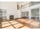 Spacious living room with a soaring ceiling, fireplace, and hardwood floors, enhancing its appeal at 12004 Willingdon Rd, Huntersville, NC 28078
