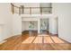 Elegant living room with hardwood floors, high ceilings, and a seamless transition to other areas at 12004 Willingdon Rd, Huntersville, NC 28078