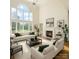 Bright living room with soaring windows, fireplace, and neutral decor, creates an inviting space at 12004 Willingdon Rd, Huntersville, NC 28078