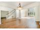 Spacious living room with large windows, high ceilings, and gleaming hardwood floors at 12004 Willingdon Rd, Huntersville, NC 28078