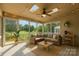 Cozy sunroom with skylights, ceiling fan, and ample natural light at 12004 Willingdon Rd, Huntersville, NC 28078