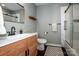 Modern bathroom with a wood cabinet sink and walk in shower at 142 Gray Barn Dr, Troutman, NC 28166