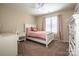 Cozy bedroom with a pink color scheme, natural light, and carpeted floors at 142 Gray Barn Dr, Troutman, NC 28166