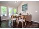 Bright dining area featuring hardwood floors, table with seating for four, and natural light from large windows at 142 Gray Barn Dr, Troutman, NC 28166