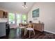 Inviting dining area boasting wood floors, stylish table with seating, and tranquil views of the outdoors at 142 Gray Barn Dr, Troutman, NC 28166