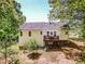 Rear exterior view of a charming home, featuring a wooden deck and well-maintained yard at 142 Gray Barn Dr, Troutman, NC 28166