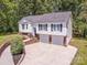 Charming two-story home with white siding and a two-car garage at 142 Gray Barn Dr, Troutman, NC 28166