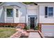 Inviting entrance with brick steps and decorative plants at 142 Gray Barn Dr, Troutman, NC 28166